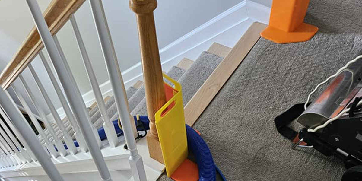 Close-up of a steam cleaning machine removing tough stains from a household carpet.