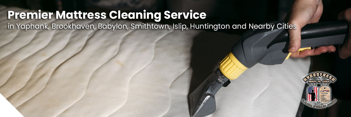 A professional technician deep-cleaning a mattress using steam equipment.